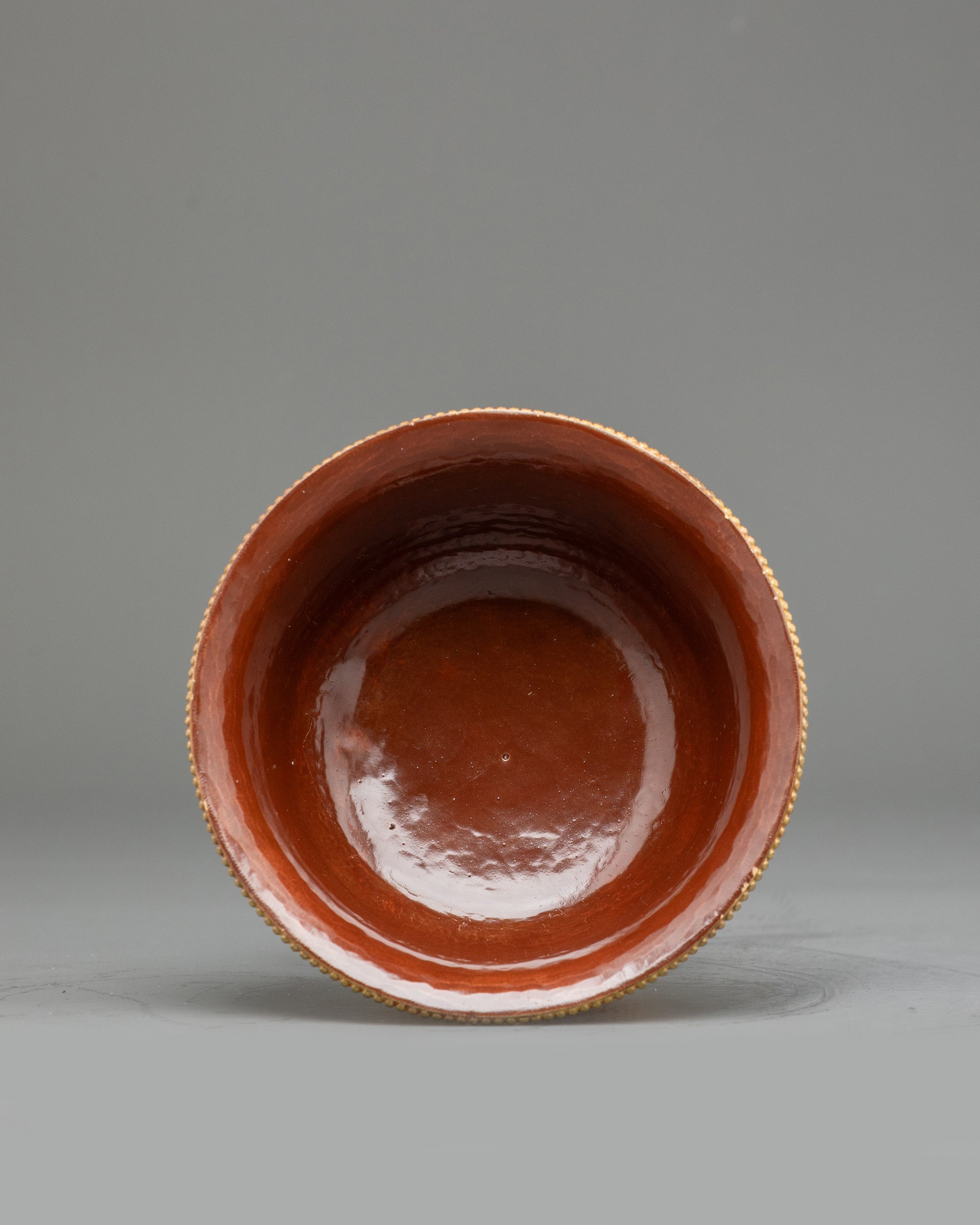 Angled view gold-plated Tibetan water offering bowls arranged for Buddhist altar practice