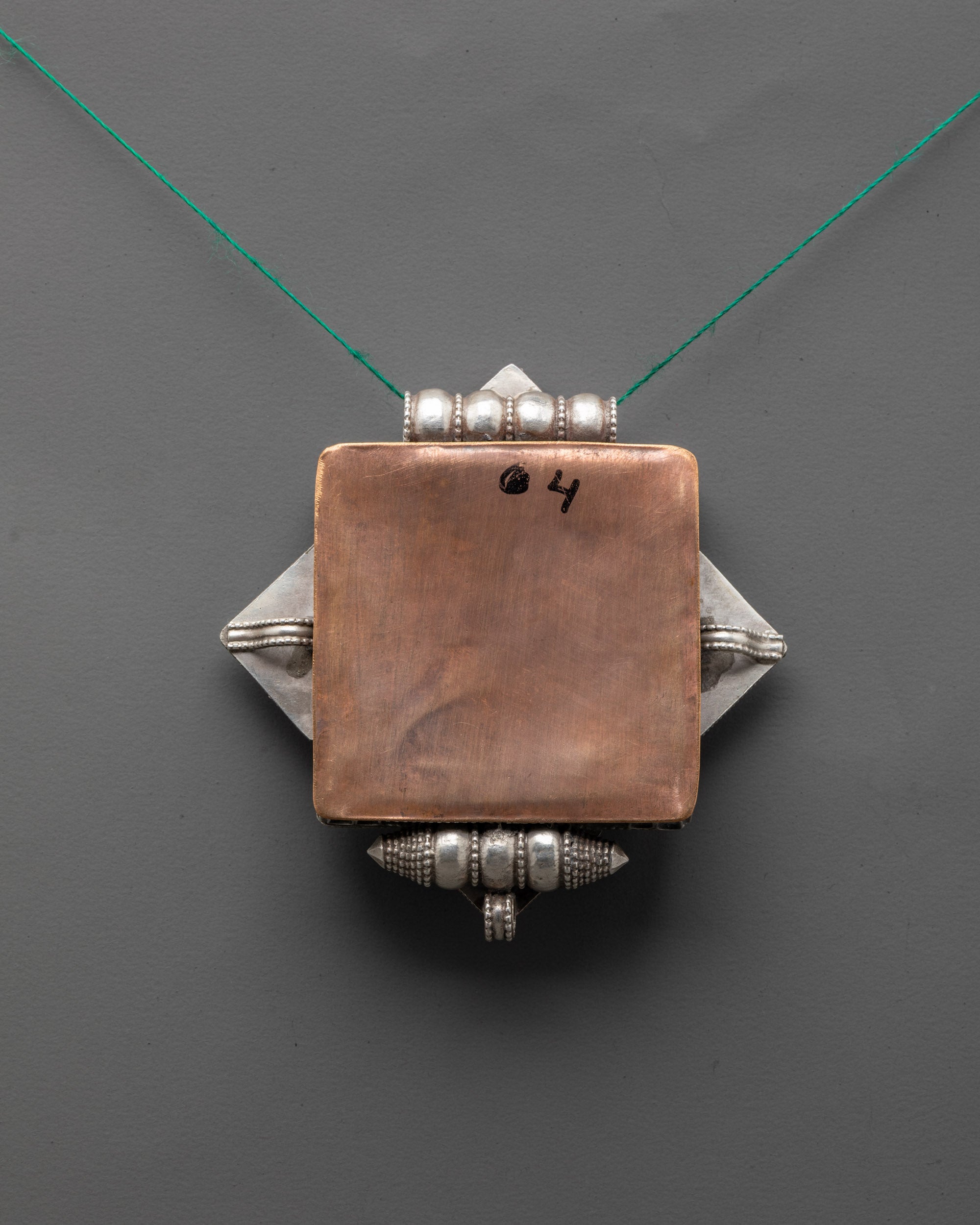 Artisan-crafted Endless Knot Necklace with silver filigree and turquoise stone centerpiece