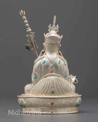 Artisan crafting a traditional Guru Rinpoche statue by hand with lost wax method, highlighting the detailed carving and painting process.






