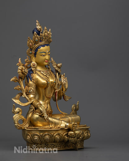 Artisan from Nepal skillfully crafting the Green Tara Statue using the traditional lost wax method in a workshop setting.