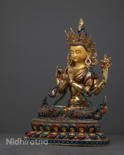 Artisan handcrafting a Chenrezig statue in Nepal using the traditional lost wax technique with detailed stone and gold adornments.