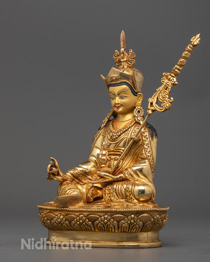 Artistic representation of Guru Rinpoche holding vajra and skull cup, surrounded by symbolic flames, showcasing hand-carved details and spiritual symbolism.