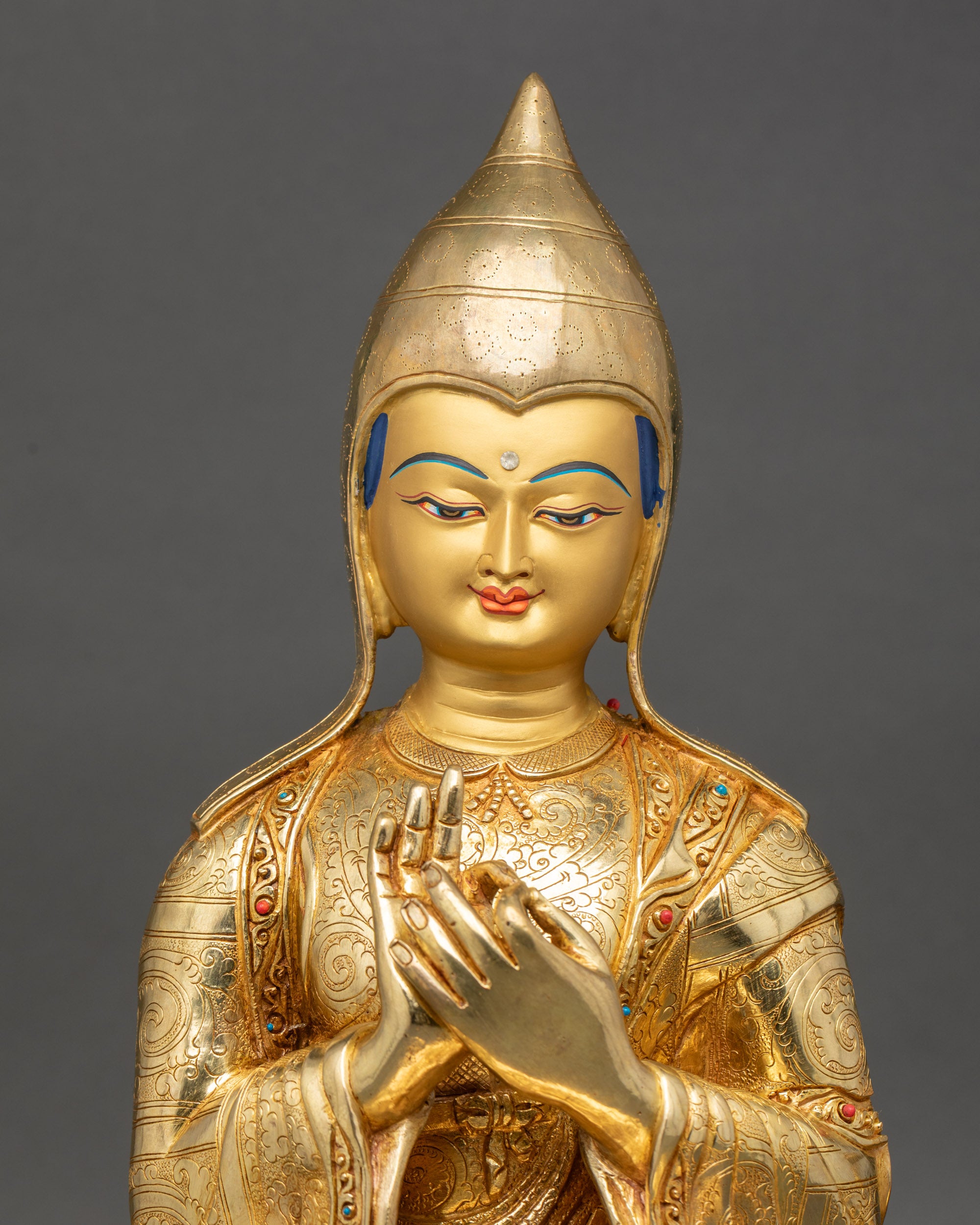 Atisha Statue close up showing gold-gilded face and lotus seat details