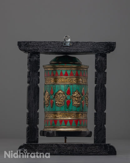 Auspicious Prayer Wheel placed on shrine with dark wood frame, copper body, and sacred Tibetan symbols