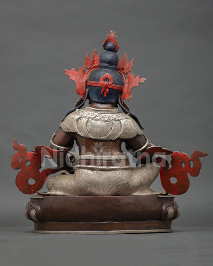 Back view of Dzambhala statue with ornate robe patterns and traditional Nepalese craftsmanship