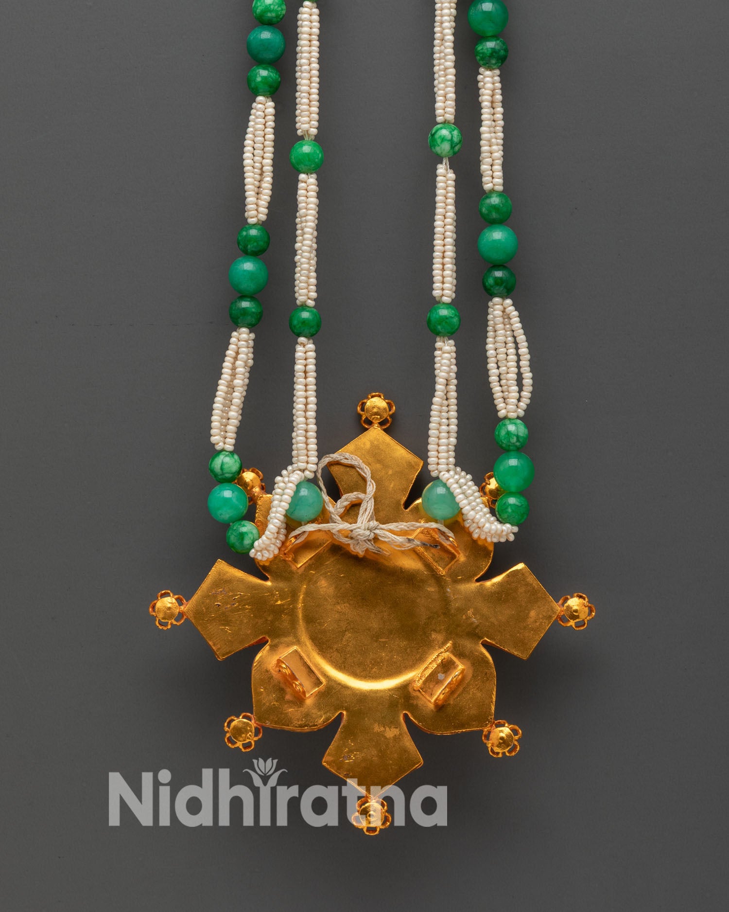 Back view of Ghau Mala gold-plated beads intricate Himalayan artistry spiritual home altar décor