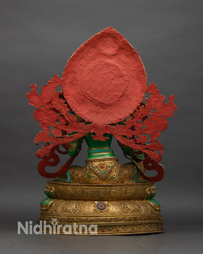 Back view of Green Tara statue showing lotus pedestal, mandorla halo, turquoise inlays