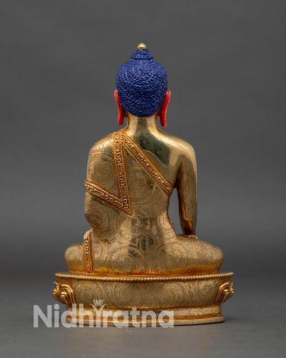Back view of Shakyamuni Buddha statue, intricate floral robes and lotus pedestal copper gold