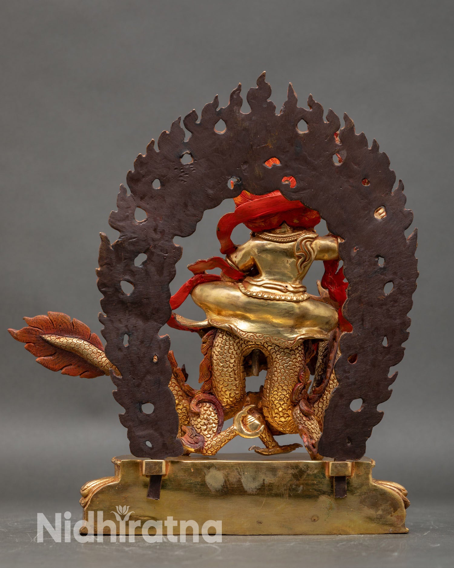 Back view White Dzambhala statue blazing halo ornate robes Tibetan Buddhist sculpture