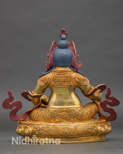 Back view of Dzambhala statue, decorated lotus pedestal and flame motifs