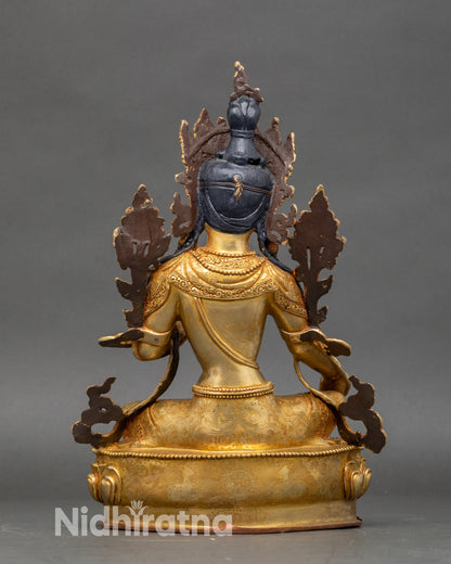 Back view of Green Tara statue, engraved lotus pedestal and decorative robes in gold finish