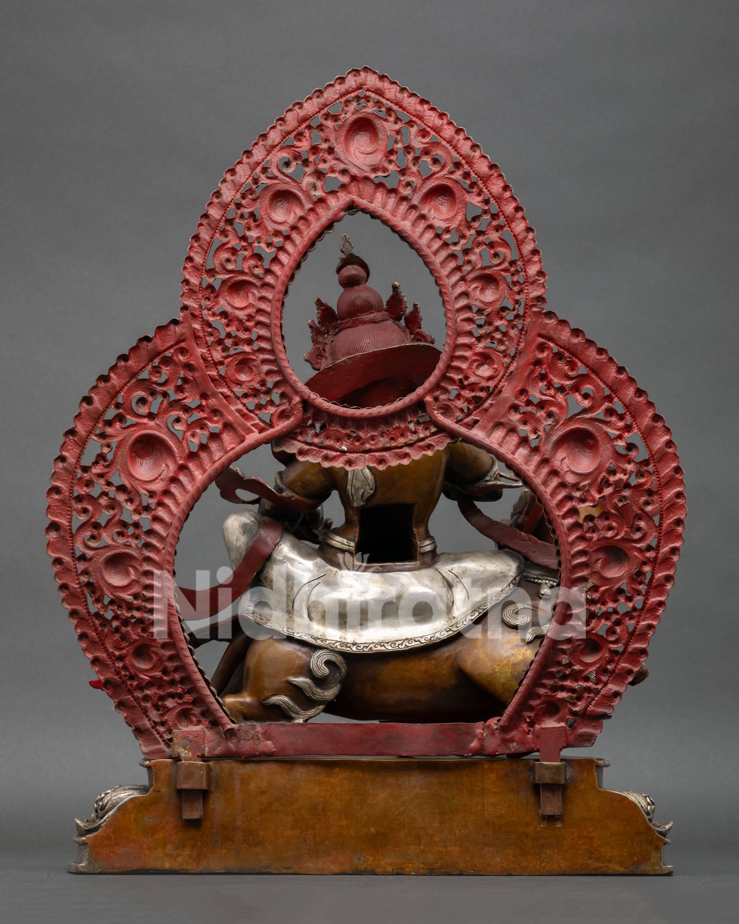 Back view of Namtoshe wealth guardian statue with intricately carved halo and traditional Nepali artistry