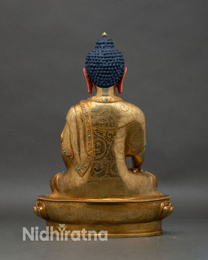 Back view of Shakyamuni Buddha statue, engraved robes and sacred lotus seat