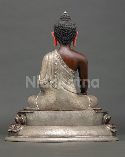 Back view of Shakyamuni Buddha statue showing detailed robe engravings and traditional Nepalese artistry