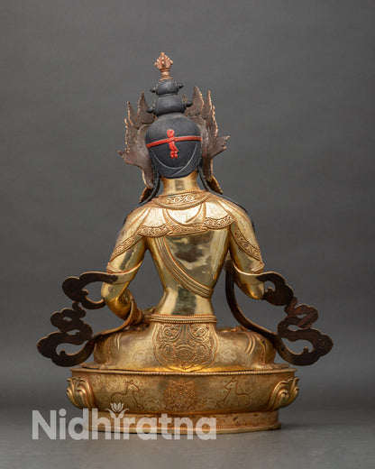Back view of Vajrasattva Buddhist statue with detailed robe carving and lotus pedestal