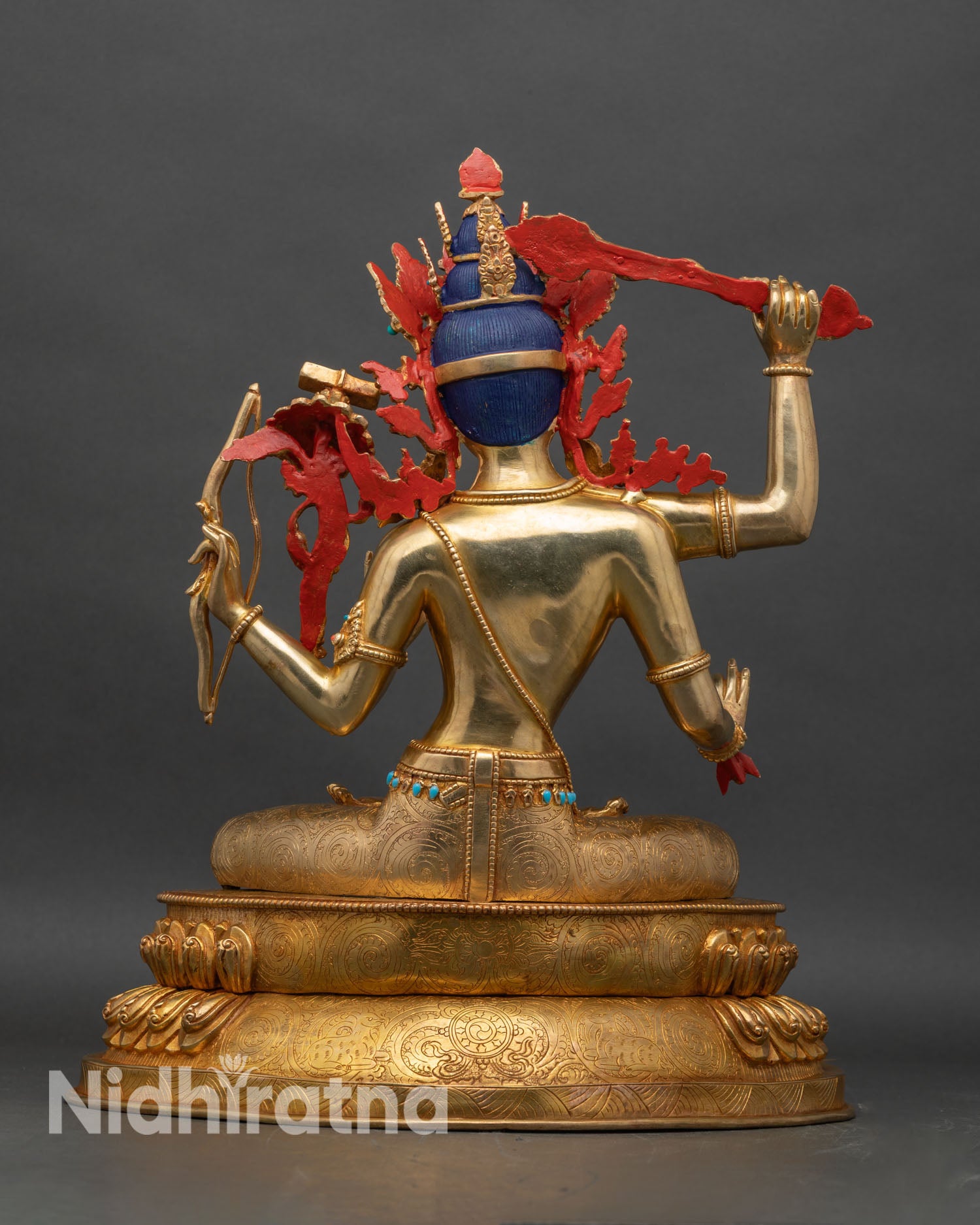 Back view of Maha Manjushri statue with detailed robe patterns and lotus throne engraving