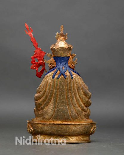 Back view of Tsokye Dorje statue with detailed robe carvings and sacred staff design