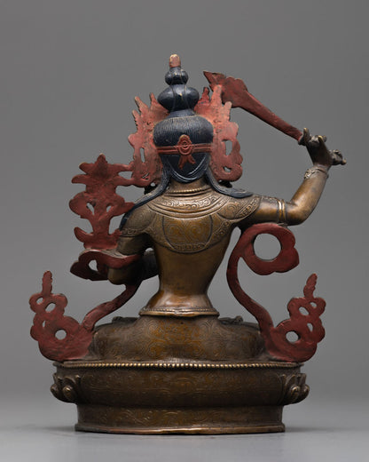 Back-view of Artisan handcrafting Manjushri statue in Patan, Nepal