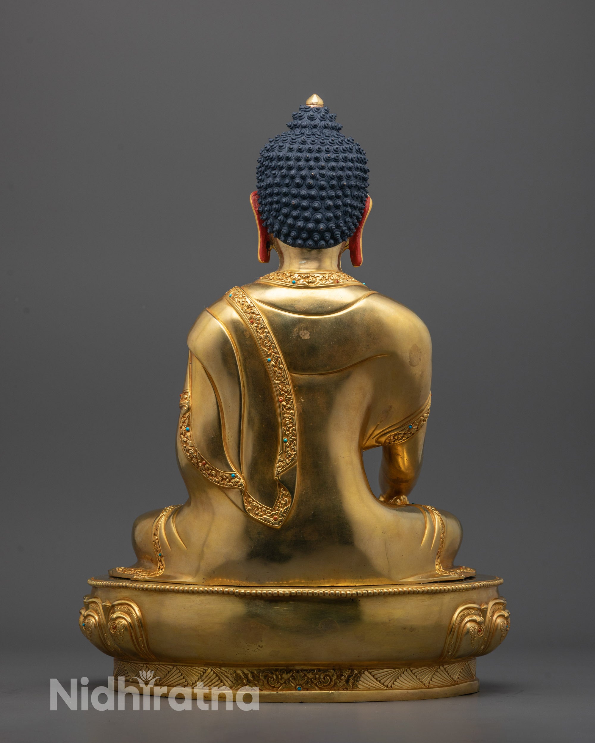Back-view of Shakyamuni Buddha Statue placed on a copper altar