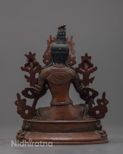 Back-view of Traditional Nepalese handmade Green Tara Buddha statue in meditative pose