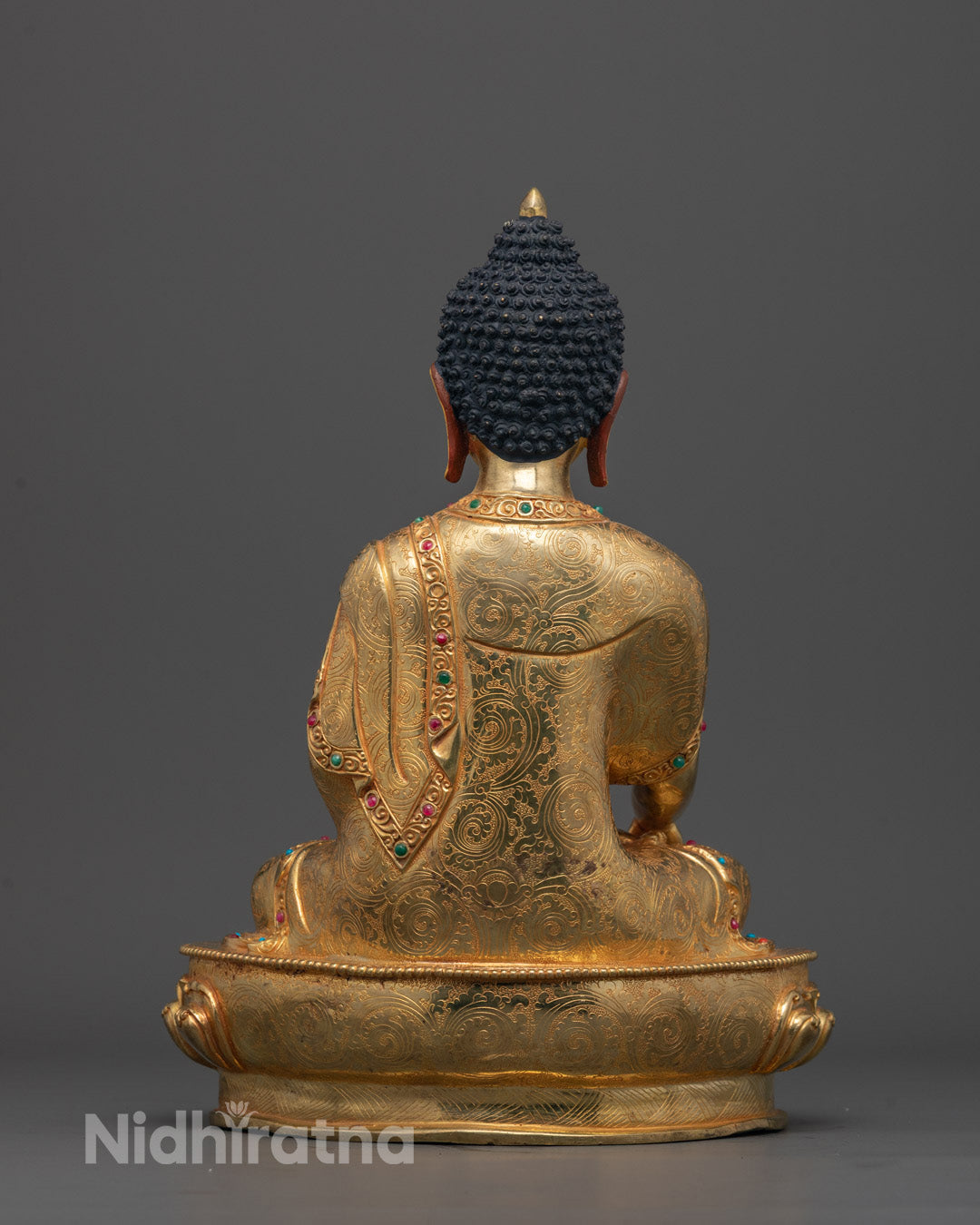 Back-view of a Traditional copper-based Shakyamuni Buddha sculpture 