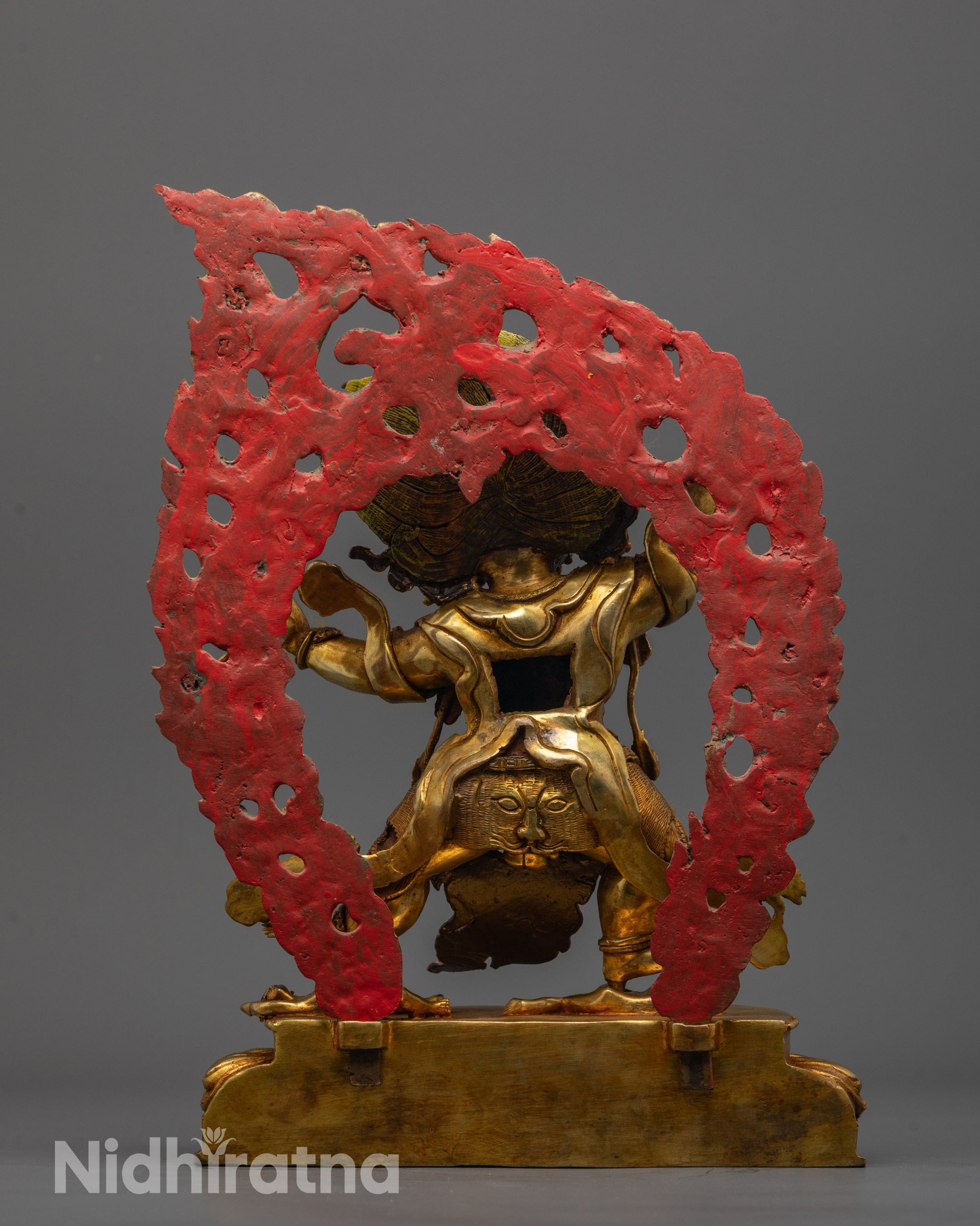 Back-view of Vajrapani Statue with lotus base and subdued human deity beneath