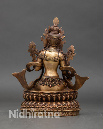Back view of White Tara statue showing lotus pedestal and detailed oxidized finish