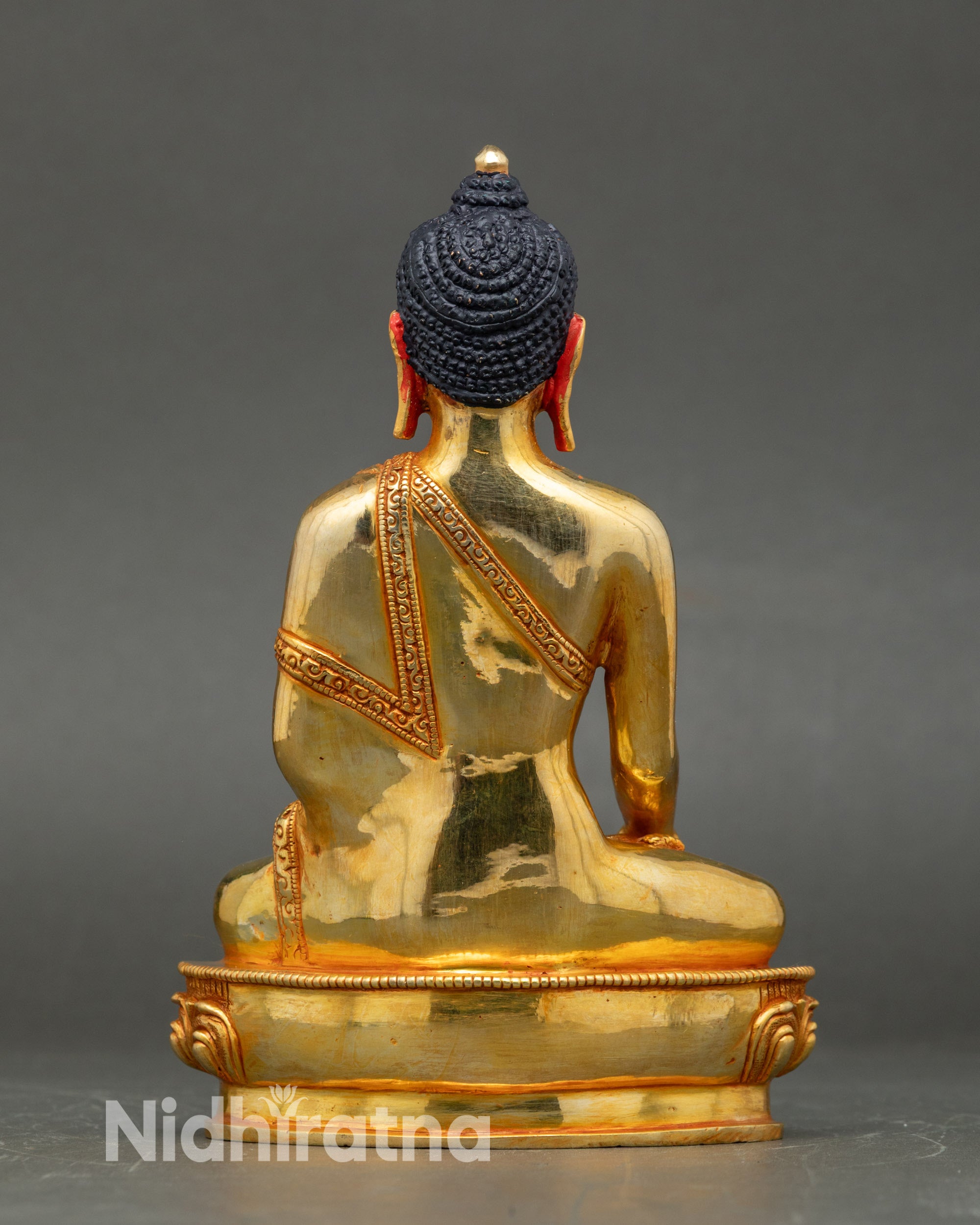 Back view of Shakyamuni Buddha statue, lotus pedestal and intricate 24K gold-gilded details