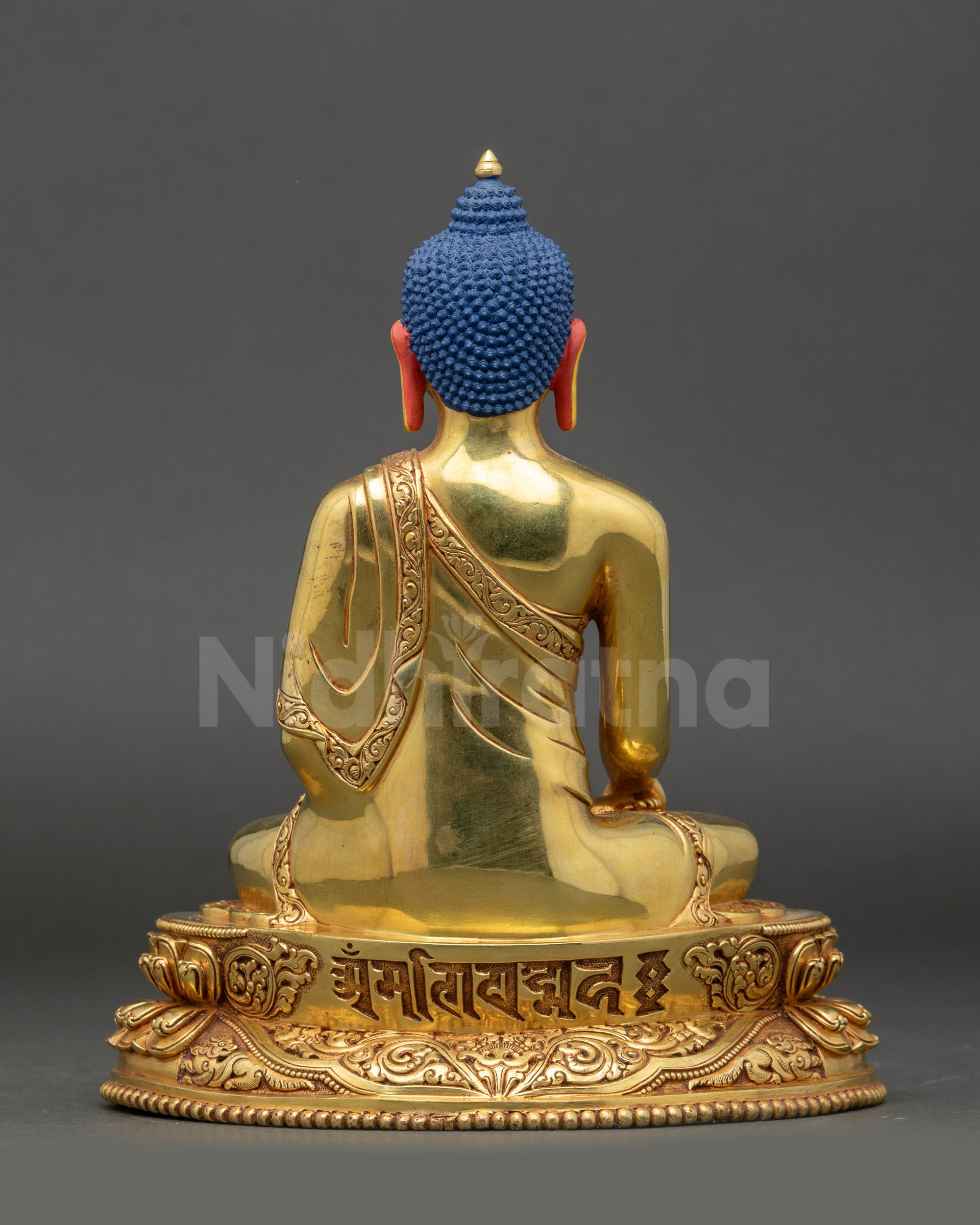Back view of Shakyamuni Buddha statue engraved with Tibetan Om Bodhi Svāhā