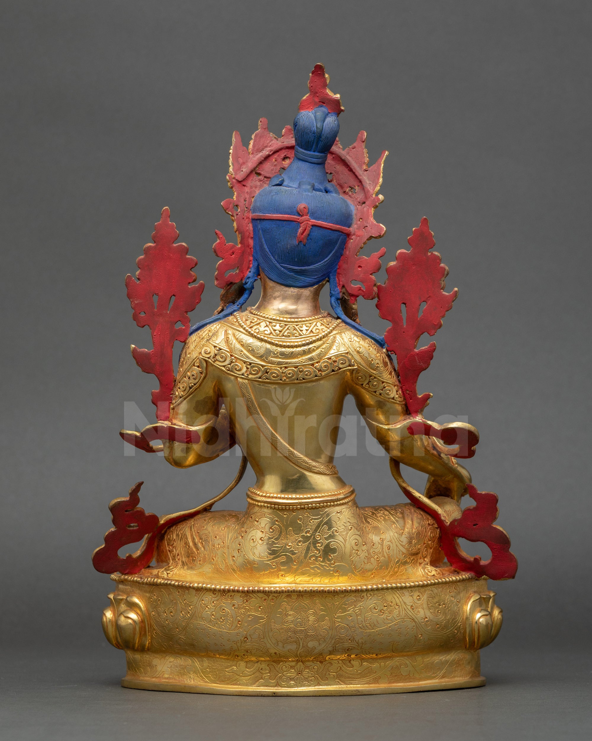 Back and shoulder view of Green Tara statue with flower motif and intricate gold details