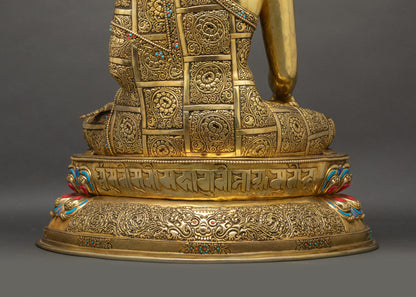 Back lower landscape Buddha Shakyamuni Statue showing monk's robe filigree, mantra, and Garuda head