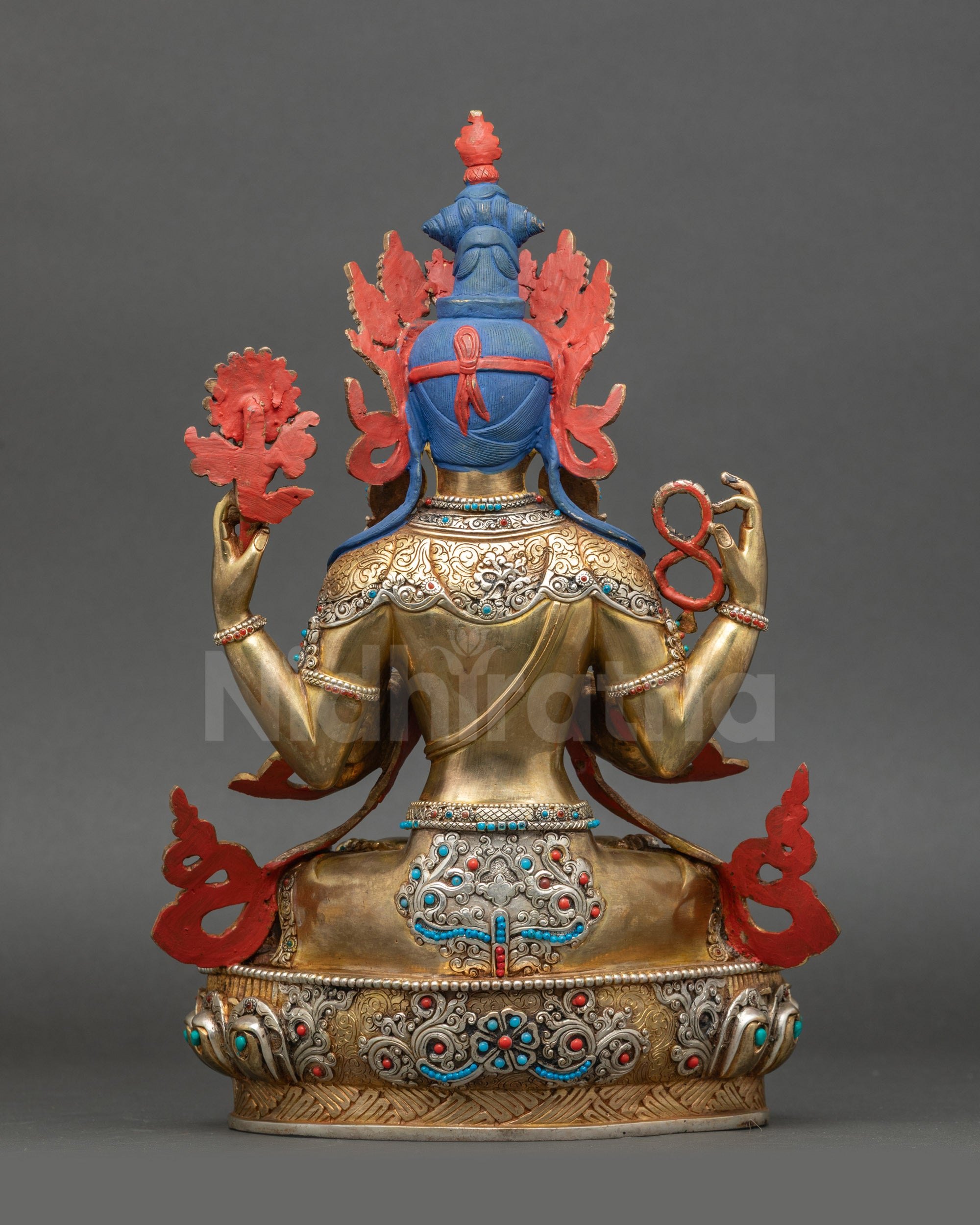 Back of Avalokiteshvara sculpture showing detailed carved robe and gold-gilding