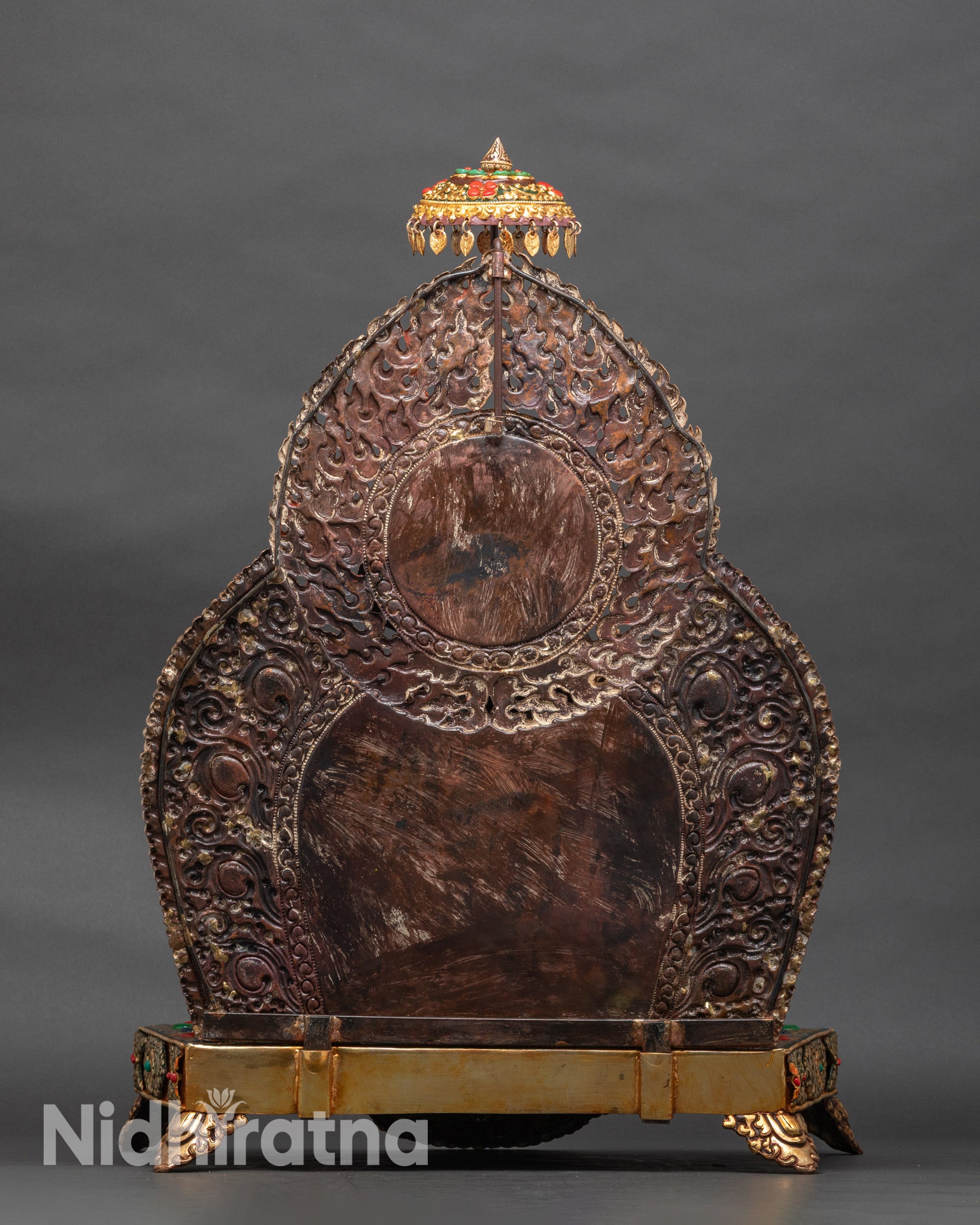 Back of Black Dzambhala statue showing ceremonial parasol and ornate details