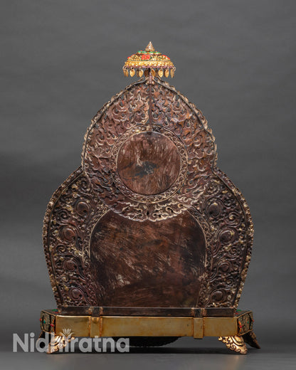 Back of Black Dzambhala statue showing ceremonial parasol and ornate details