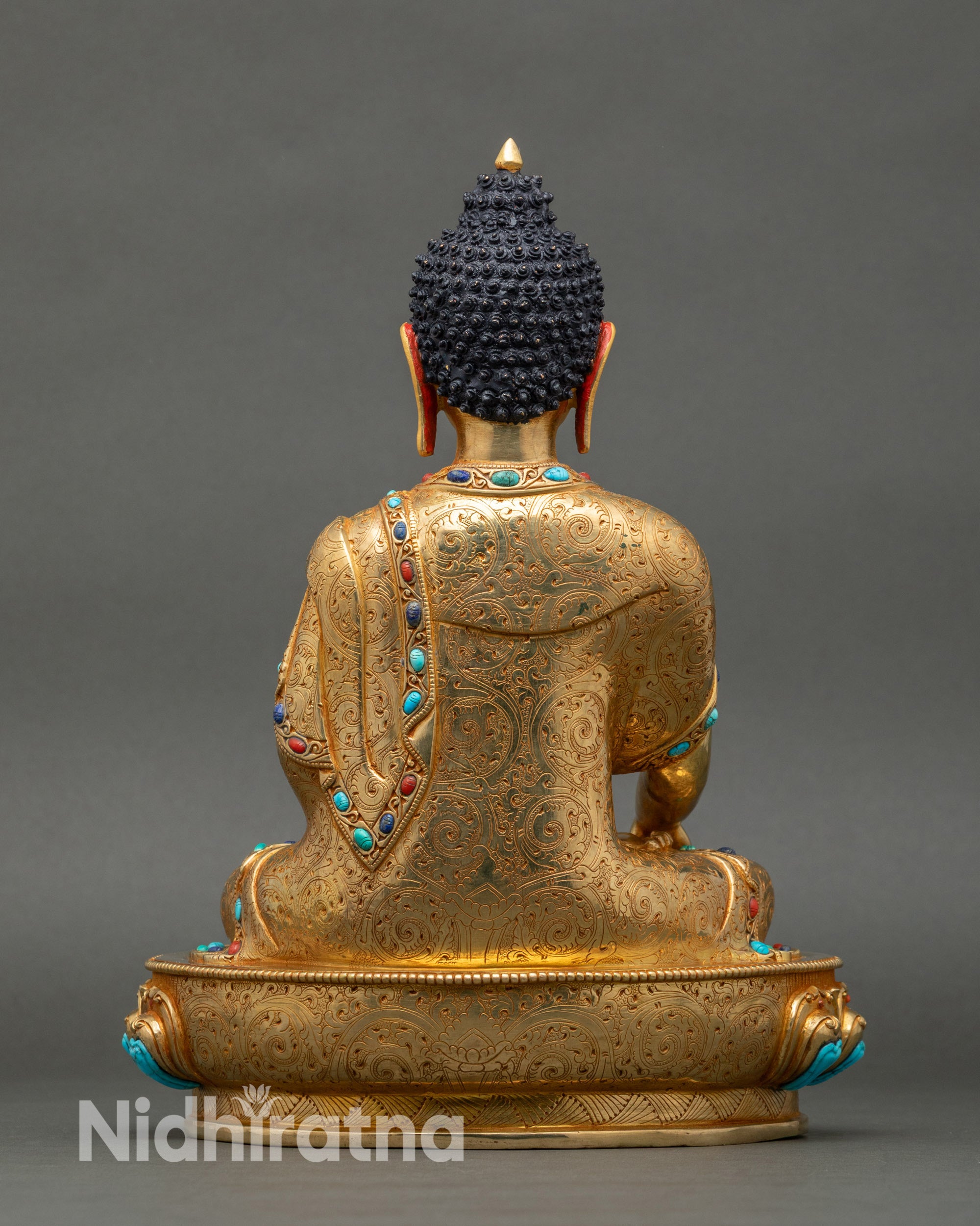 Back of Buddha statue showing carved robes and lotus base, Nepalese artistry