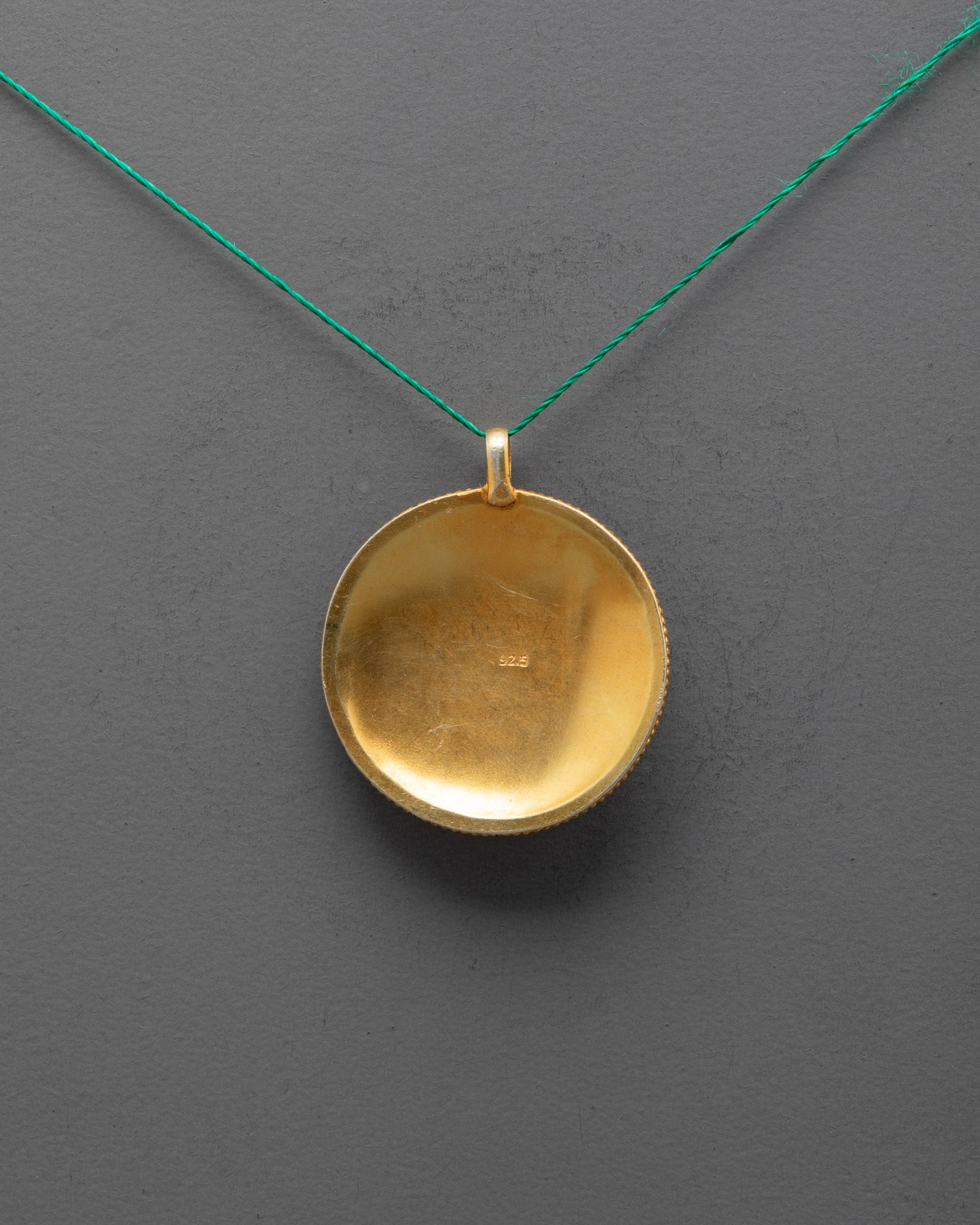 Back of Mandala Locket Pendant highlighting detailed craftsmanship and copper base

