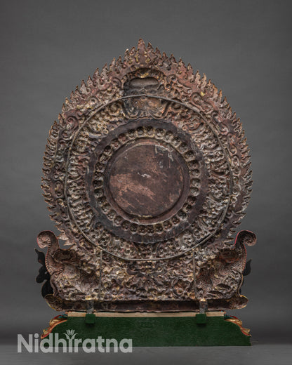 Back of Vajrapani statue showing ornate Garuda floral halo and lotus pedestal with carvings