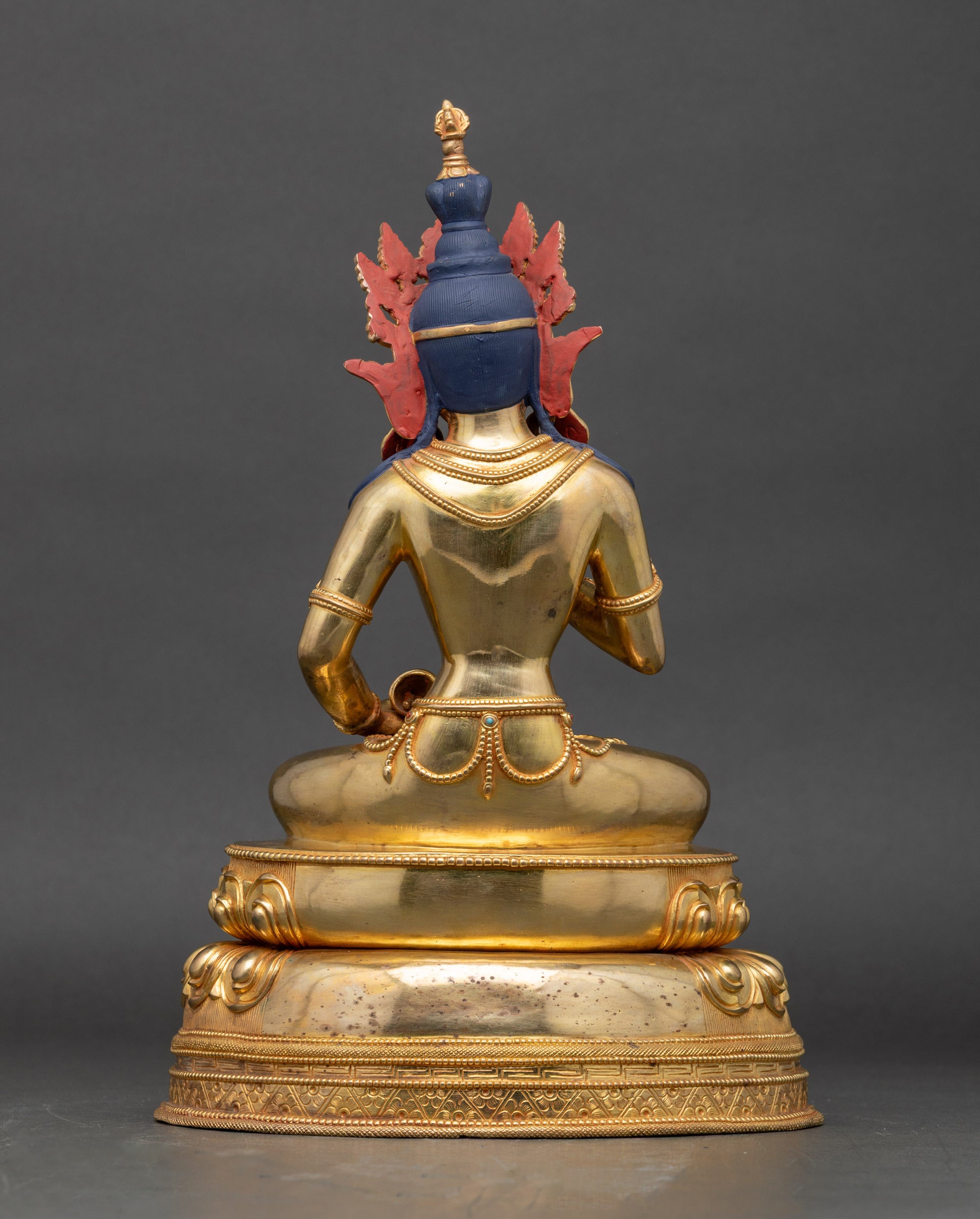 Back of Vajrasattva statue showing detailed robe folds and lotus layers