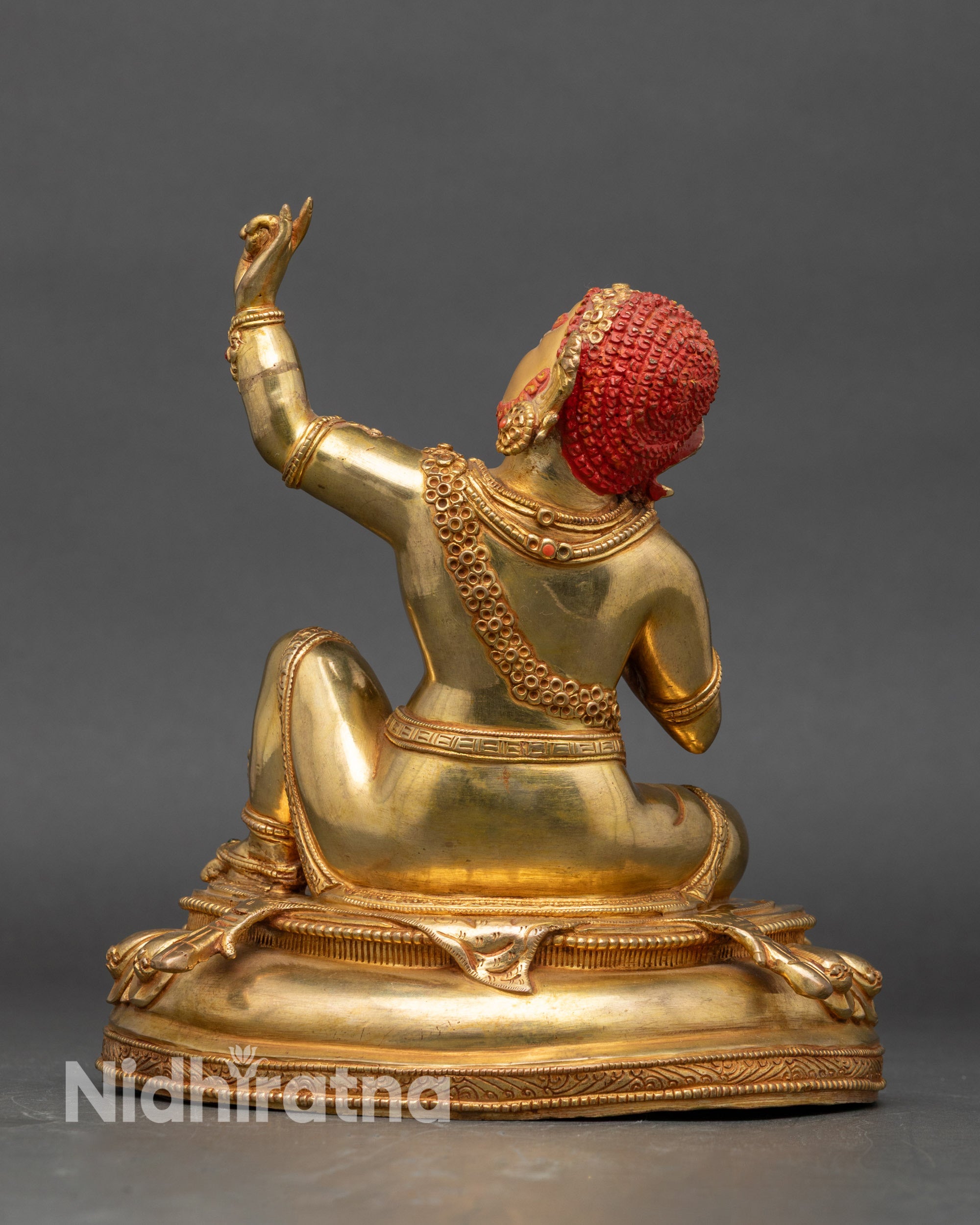 Back of Virupa statue with carved lotus seat and detailed traditional attire