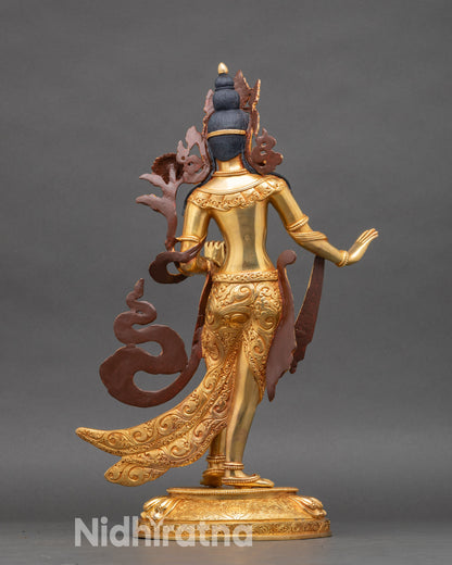 Back of White Tara statue showing detailed floral carvings and ornate crown