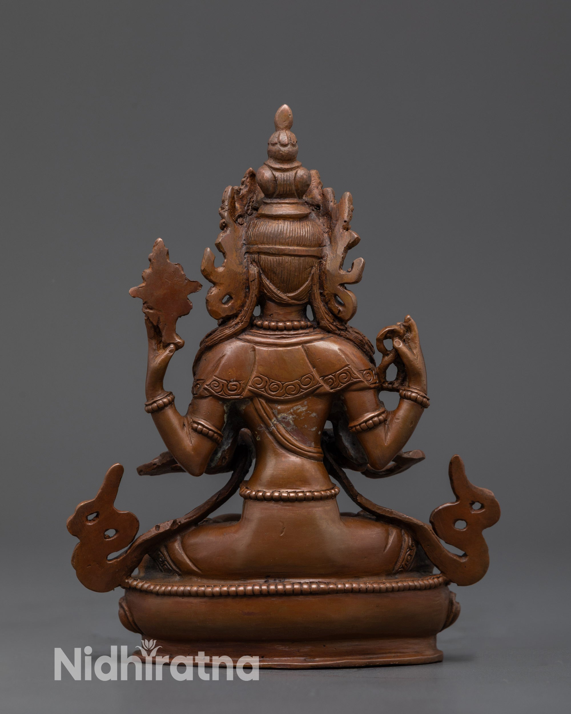 Back view Avalokiteshvara Statue showing flowing carved garments and armlets