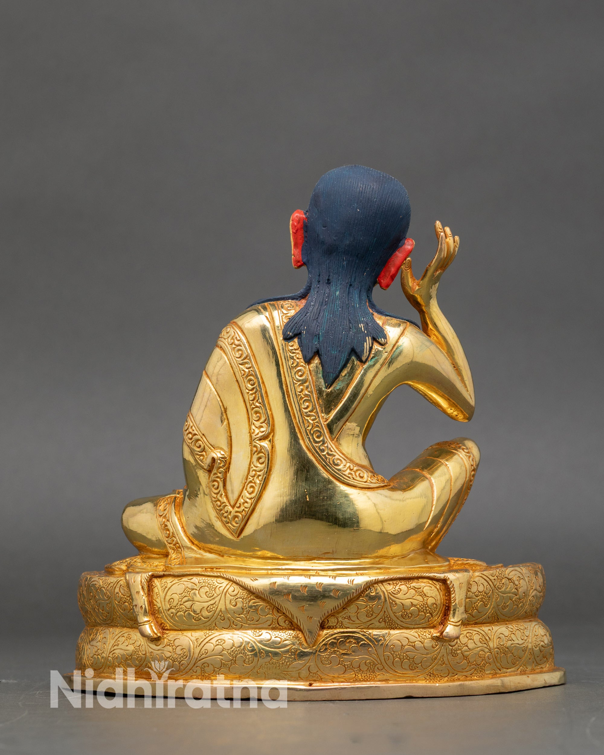Back view – Back of Milarepa statue showing engraved pedestal and detailed gilded robes
