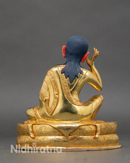 Back view – Back of Milarepa statue showing engraved pedestal and detailed gilded robes