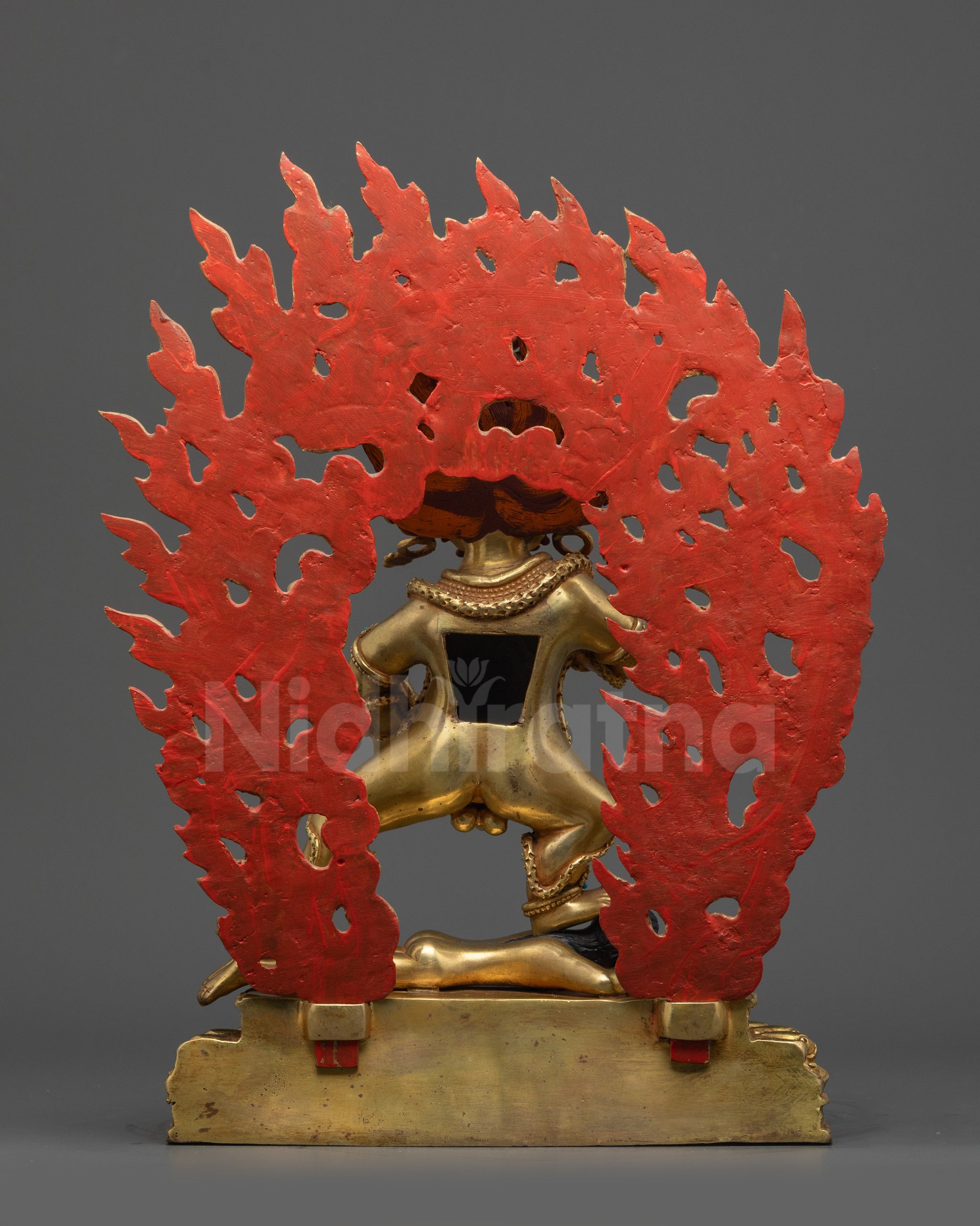 Back view Black Dzambhala Statue showing robe details and fire-gilded body