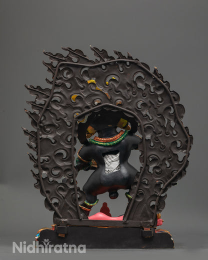 Back view Black Dzambhala statue showing wrathful halo and detailed multi colored seat