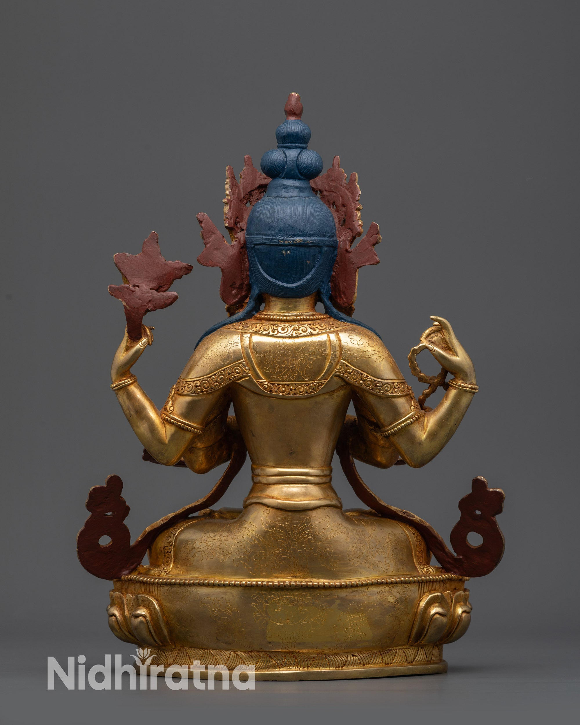 Back view Chenrezig sculpture showing swirling robe patterns and lotus seat details