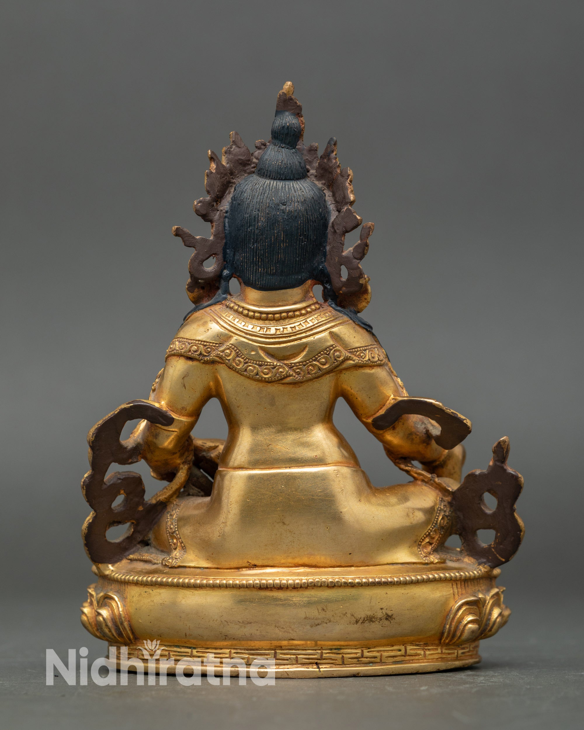Back view Dzambhala sculpture showing intricate jewelry, robes, and Nepalese craftsmanship