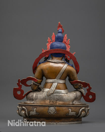 Back view Dzambhala statue showing detailed carvings, silver-plated decorations, and ornaments