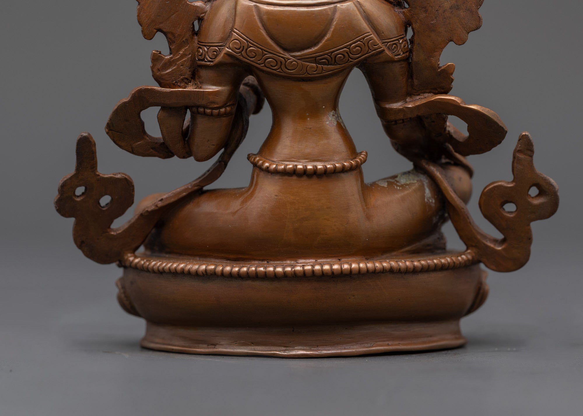 Back view Green Tara seated in royal ease mudra with flowing robe and jeweled lotus seat