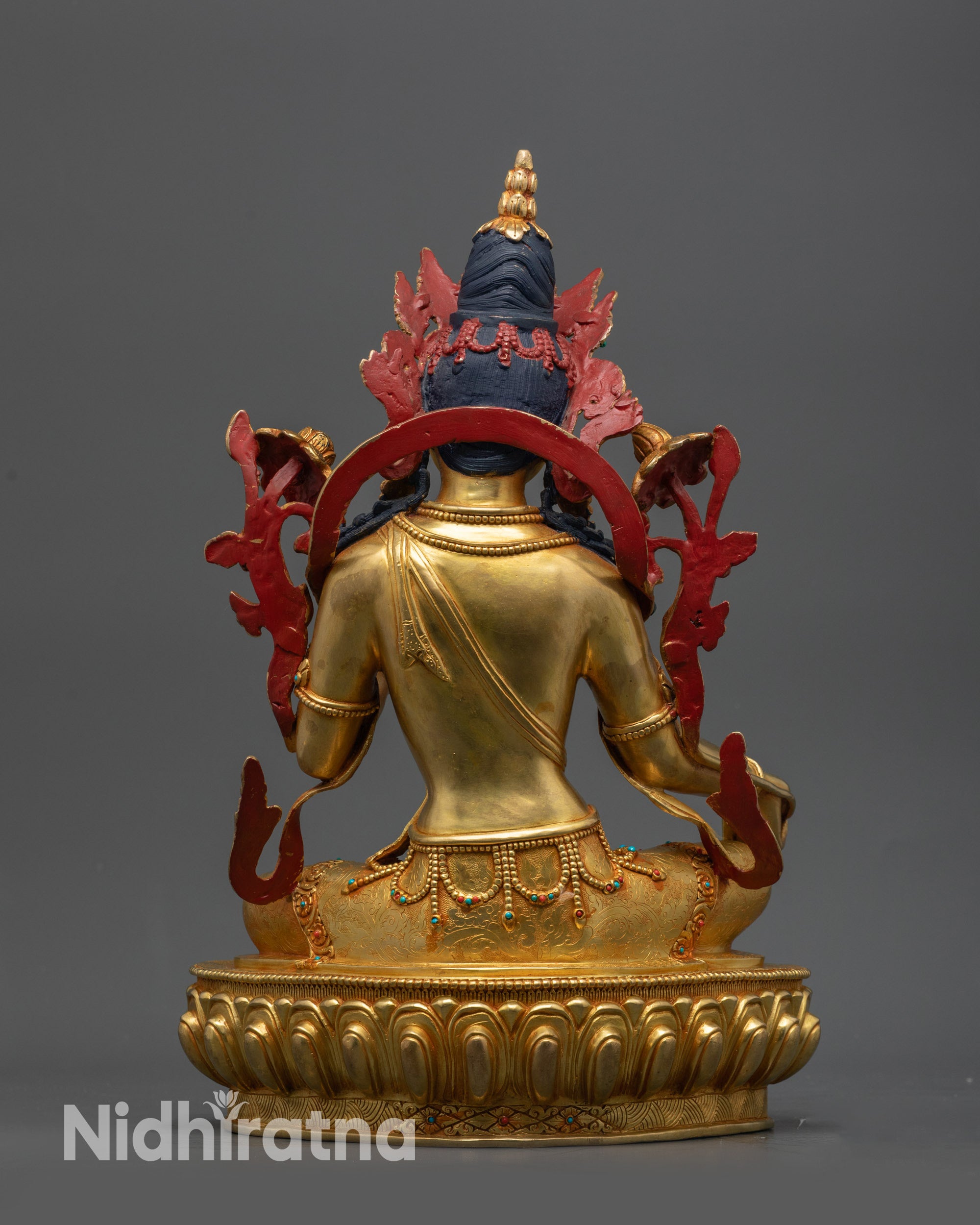 Back view Green Tara statue highlighting intricate carved jewelry and flowing robe